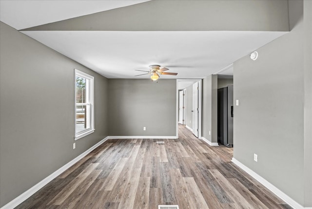 unfurnished room with hardwood / wood-style flooring and ceiling fan