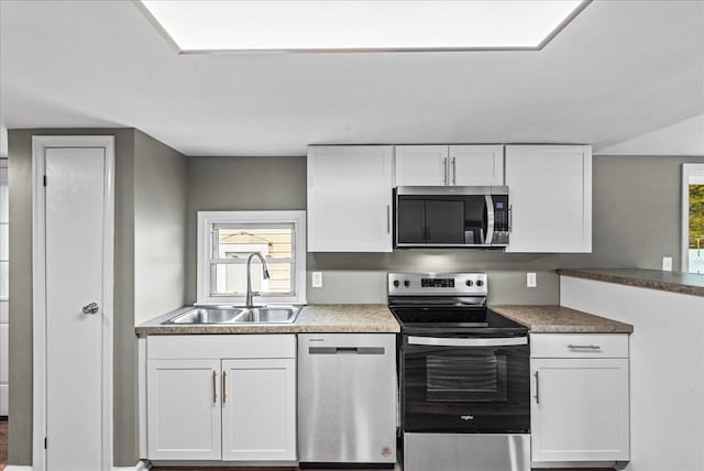 kitchen featuring white cabinetry, stainless steel appliances, and sink