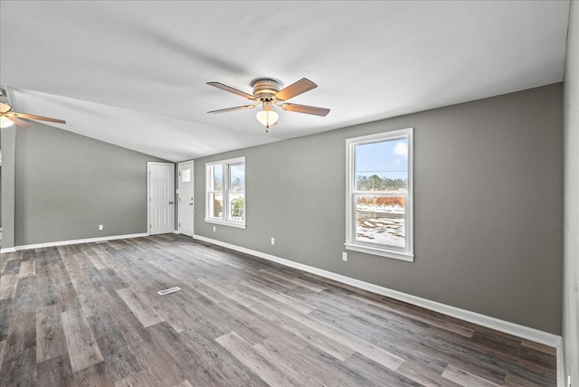 empty room featuring ceiling fan, wood-type flooring, and vaulted ceiling