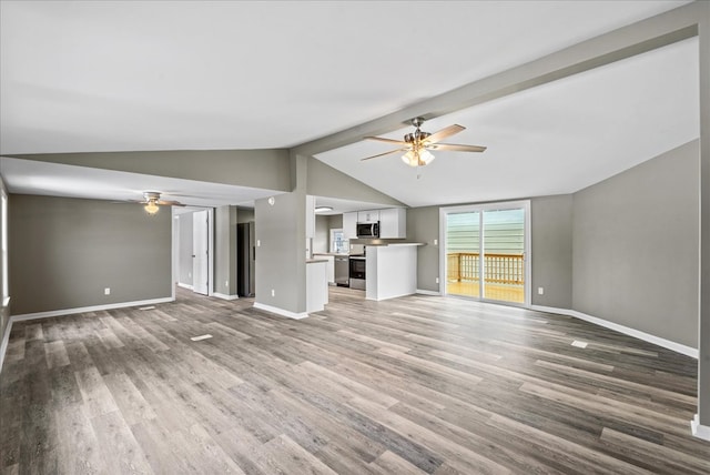 unfurnished living room with hardwood / wood-style flooring, ceiling fan, and vaulted ceiling with beams