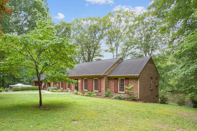 383 Monroe St, Montross, VA 22520 - view of front of home with brick siding, a front lawn, a chimney, and roof with shingles