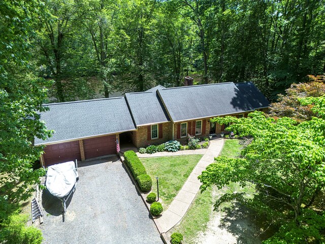 383 Monroe St, Montross, VA 22520 - view of front of home featuring a garage, gravel driveway, roof with shingles, brick siding, and a front yard
