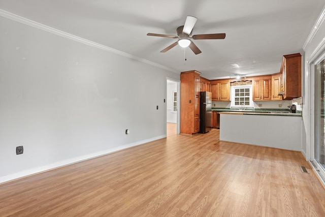 383 Monroe St, Montross, VA 22520 - kitchen with freestanding refrigerator, dark countertops, open floor plan, light wood-style floors, and a sink