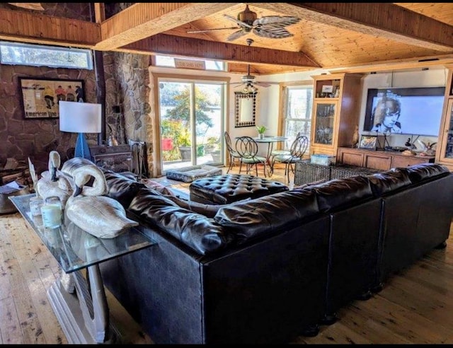 living area with vaulted ceiling with beams, wooden ceiling, wood finished floors, and a ceiling fan