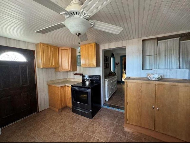 kitchen with ceiling fan, black range with electric cooktop, tile patterned flooring, wood ceiling, and light countertops