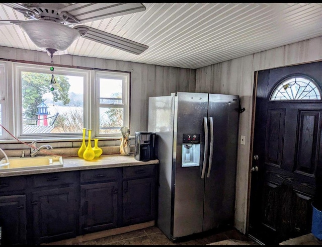 kitchen with a sink, a wealth of natural light, stainless steel refrigerator with ice dispenser, and light countertops