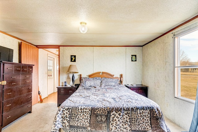 bedroom featuring light carpet, multiple windows, a textured ceiling, and crown molding