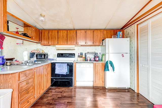 kitchen with dark wood-type flooring, white appliances, light countertops, and under cabinet range hood