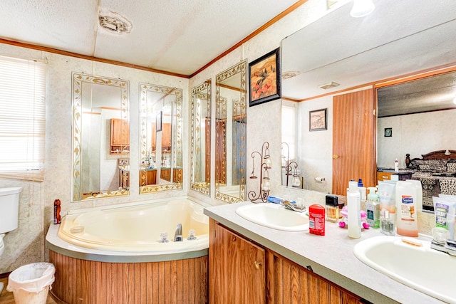 bathroom with a garden tub, crown molding, a textured ceiling, and a sink