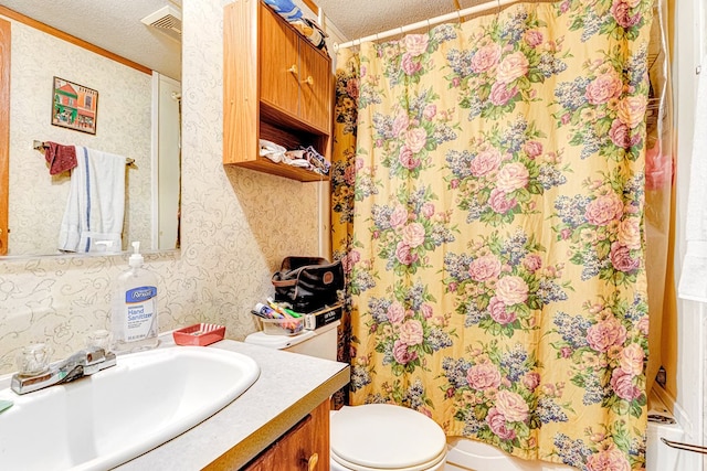 full bath featuring wallpapered walls, visible vents, toilet, a textured ceiling, and vanity