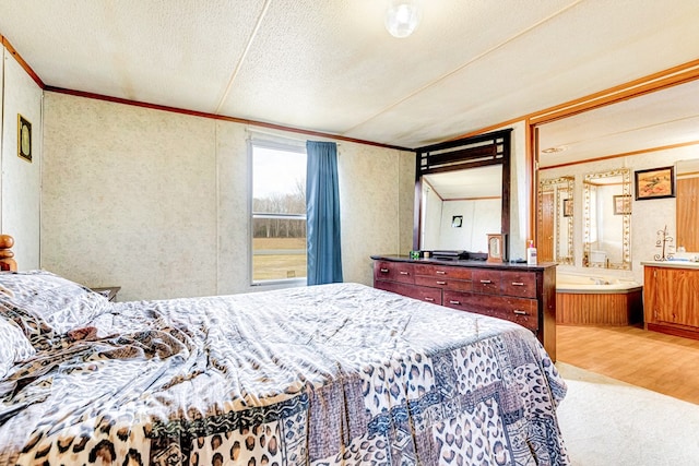 bedroom with connected bathroom, crown molding, a textured ceiling, and wood finished floors