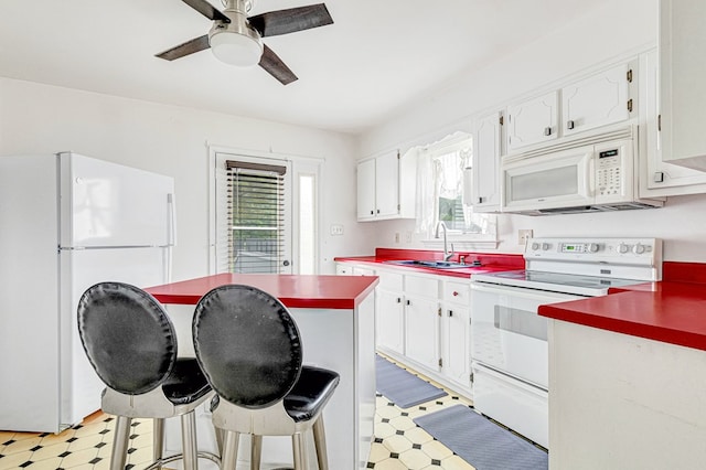 725 Cralle Ave, Tappahannock, VA 22560 - kitchen with white appliances, light floors, a ceiling fan, and white cabinets