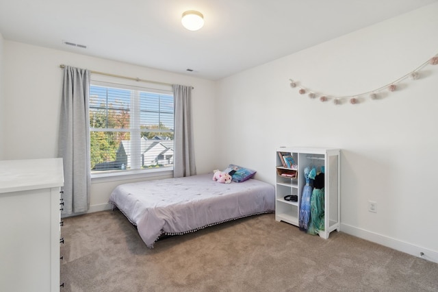 carpeted bedroom featuring multiple windows