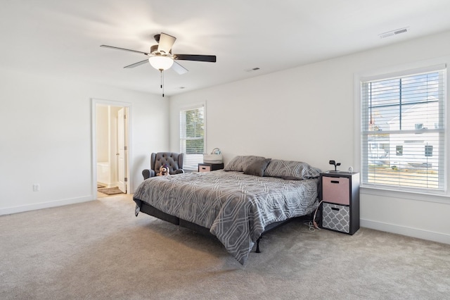 carpeted bedroom featuring ensuite bath and ceiling fan