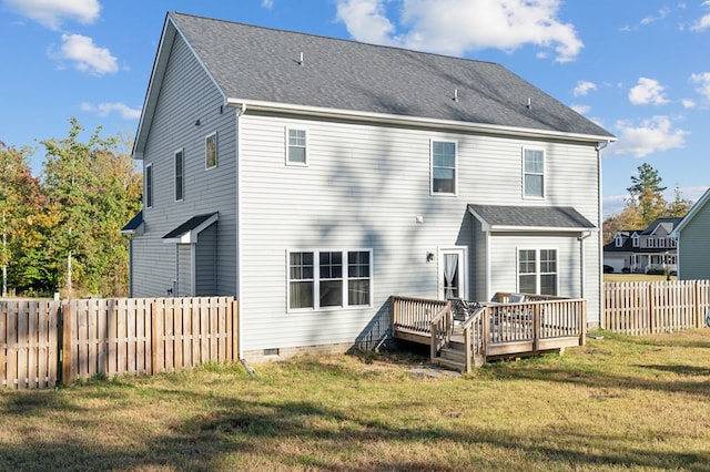 rear view of house featuring a wooden deck and a yard