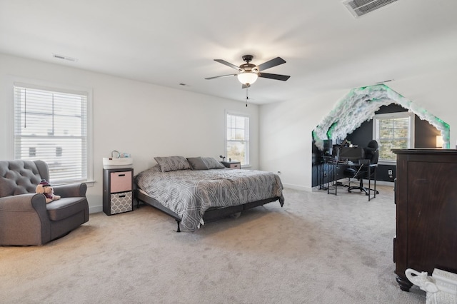 carpeted bedroom featuring multiple windows and ceiling fan