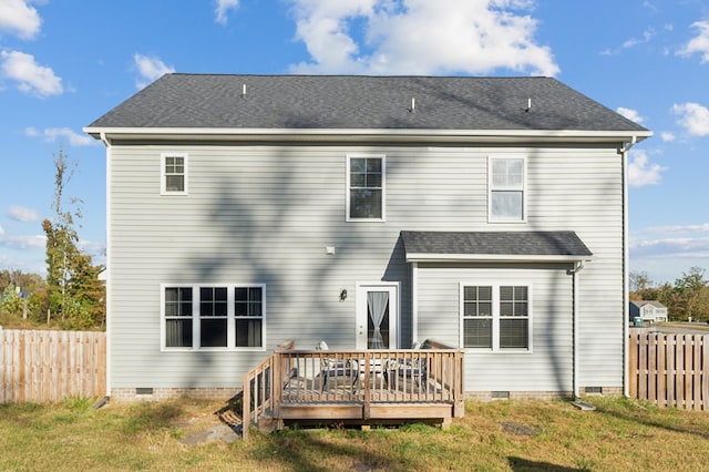 rear view of property with a lawn and a wooden deck