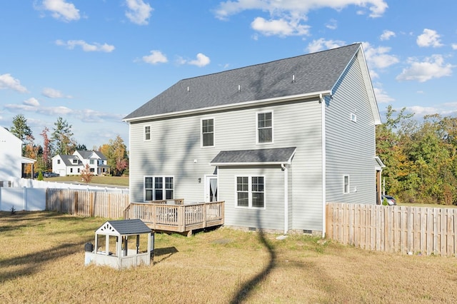 back of house with a wooden deck and a yard