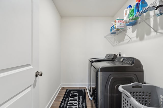 clothes washing area featuring separate washer and dryer and dark hardwood / wood-style floors