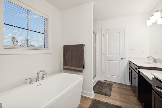 bathroom with vanity, independent shower and bath, and hardwood / wood-style flooring