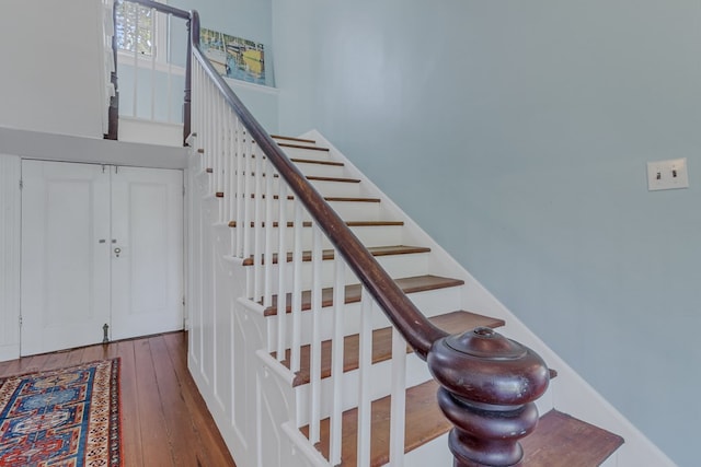 stairway with hardwood / wood-style flooring