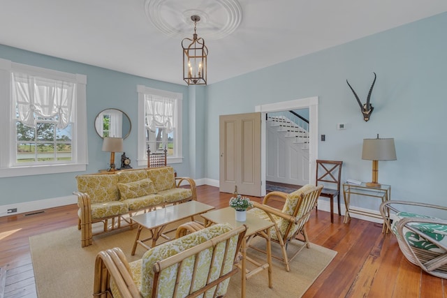 living room with hardwood / wood-style flooring and a chandelier