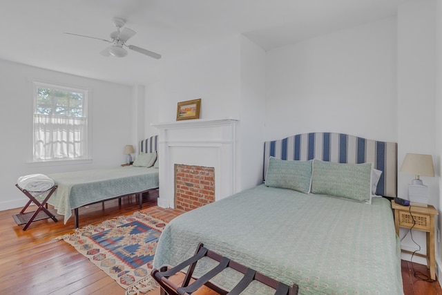 bedroom with ceiling fan and hardwood / wood-style floors