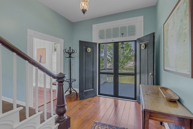 entryway featuring a healthy amount of sunlight, light hardwood / wood-style floors, and french doors