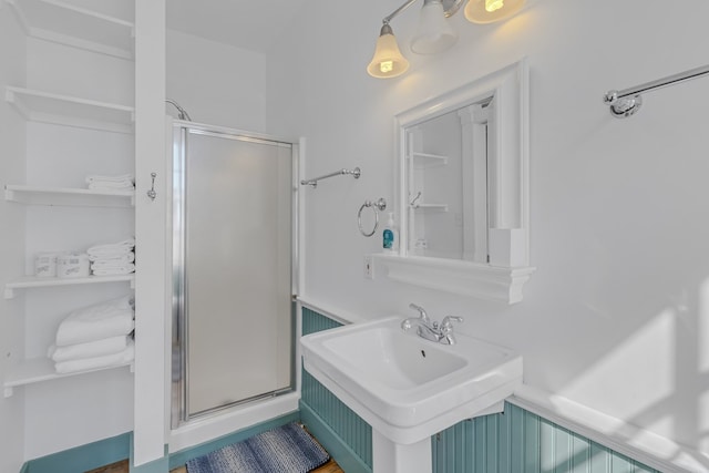 bathroom featuring sink and a shower with shower door