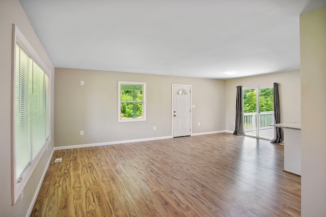 unfurnished living room with light hardwood / wood-style floors