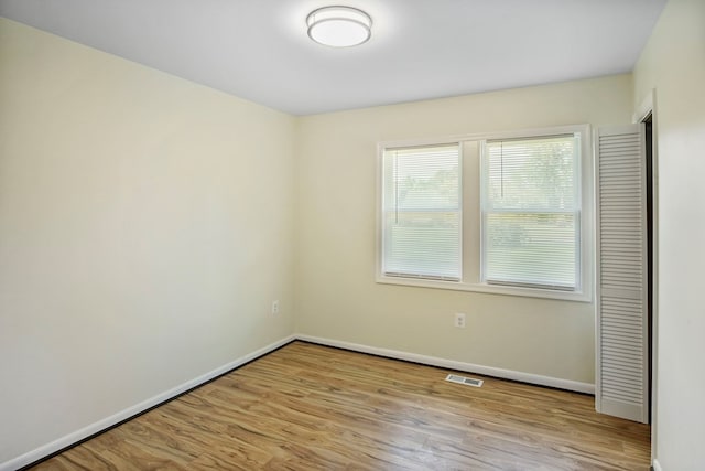 unfurnished room with light wood-type flooring