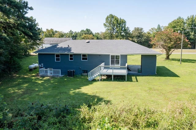 back of house with a lawn, a wooden deck, and cooling unit