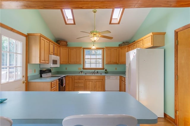 430 Pine Tree Rd, Center Cross, VA 22437 - kitchen featuring white appliances, lofted ceiling, light brown cabinetry, a skylight, and light countertops