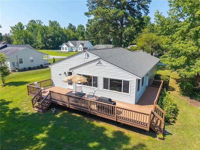 430 Pine Tree Rd, Center Cross, VA 22437 - rear view of property featuring a wooden deck, a lawn, roof with shingles, and view of scattered trees