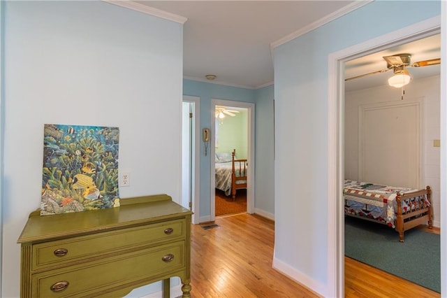 430 Pine Tree Rd, Center Cross, VA 22437 - corridor with light wood finished floors and ornamental molding