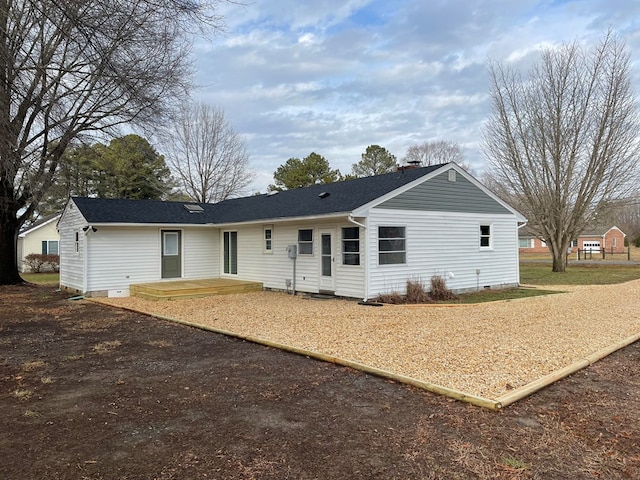 view of front of house with crawl space, a shingled roof, and a chimney