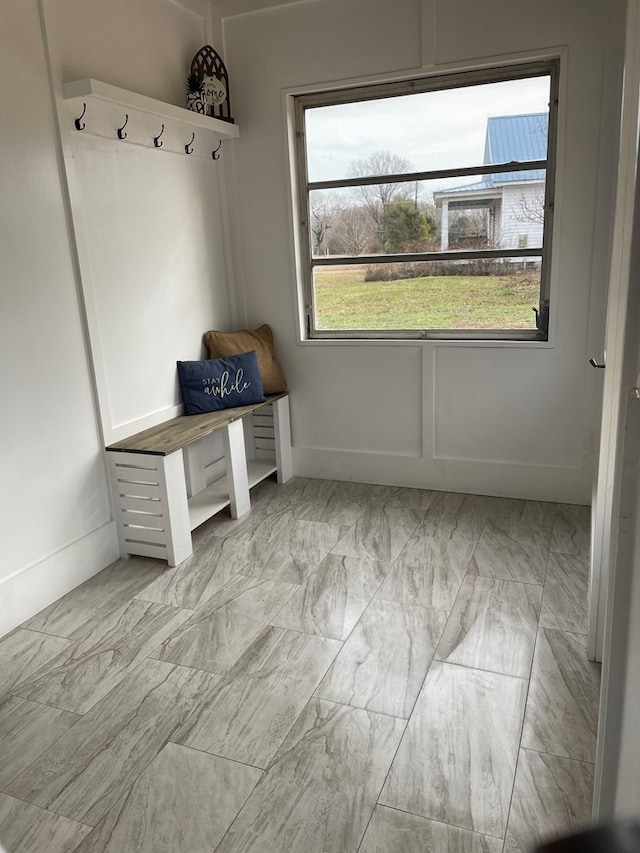 mudroom featuring marble finish floor and baseboards