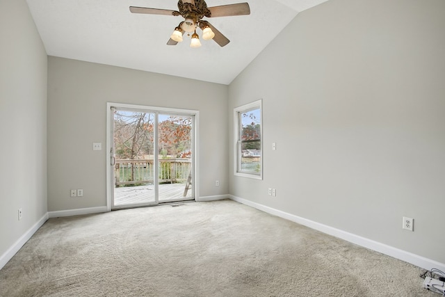 carpeted spare room with baseboards, ceiling fan, and vaulted ceiling
