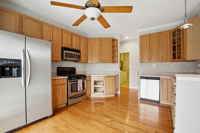 kitchen with appliances with stainless steel finishes, light countertops, and light wood-style floors
