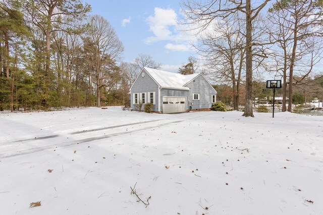 snow covered deck with a water view and a boat dock