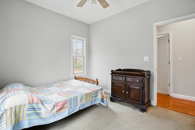 bedroom featuring a ceiling fan, baseboards, and light carpet