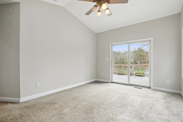 empty room featuring visible vents, lofted ceiling, ceiling fan, and carpet flooring