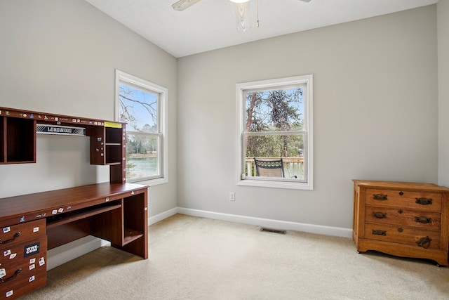 office area featuring carpet flooring, baseboards, visible vents, and ceiling fan
