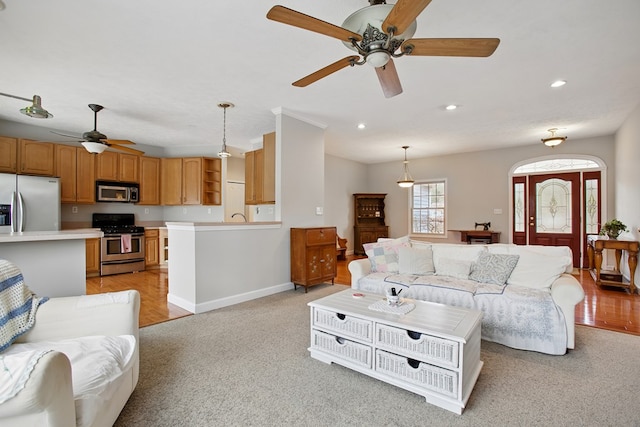 living room featuring light carpet, recessed lighting, baseboards, and a ceiling fan