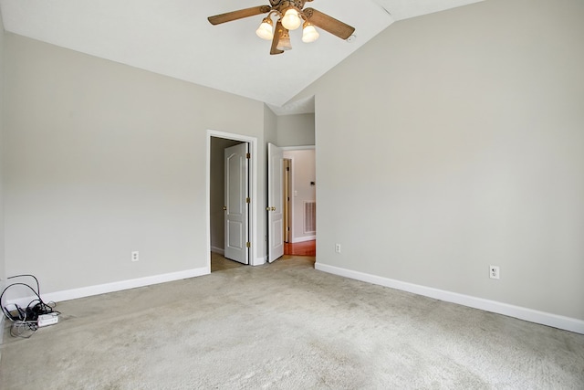 empty room featuring baseboards, high vaulted ceiling, ceiling fan, and carpet flooring