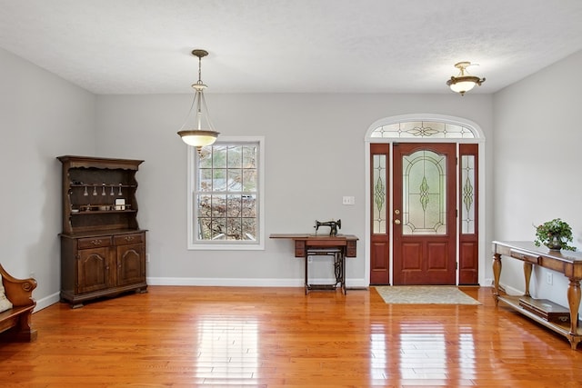 foyer entrance featuring wood finished floors and baseboards