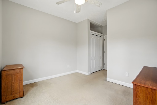 interior space with carpet flooring, baseboards, and a closet
