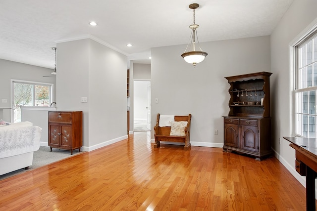 unfurnished room featuring recessed lighting, baseboards, crown molding, and light wood-style floors