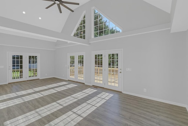 unfurnished living room featuring french doors, high vaulted ceiling, ceiling fan, and wood-type flooring