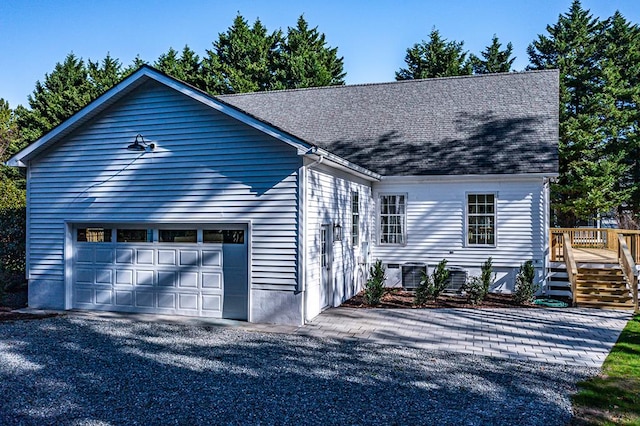 view of front of property with a garage and a deck